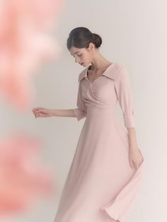 The Diamant Dress is a beautifully structured piece that exudes elegance and sophistication. This mid-length dress comes in a soft blush pink hue and features a unique, asymmetrical collar that adds a modern twist to the classic silhouette. The tailored bodice and A-line skirt provide a flattering fit, while the long sleeves with subtle cuff details enhance the dress's formal appeal. - The Diamant Dress is characterized by its distinct asymmetrical collar, offering a contemporary edge to a traditional design.- Crafted from a smooth, high-quality fabric, the dress drapes elegantly and maintains its shape throughout wear.- Its cinched waist and flowing A-line skirt accentuate the natural waistline and create a graceful, feminine profile.- Suitable for formal events and sophisticated gat Asymmetrical Collar, Dress Drape, Cuff Detail, Mid Length Dresses, Classic Silhouette, Cinched Waist, Dress Pink, A Line Skirt, Traditional Design