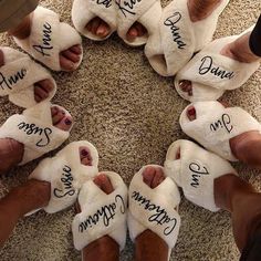 someone has written their feet in slippers with names on them