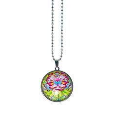 a necklace with a flower design on the front and back of it, hanging from a ball chain