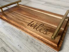 a wooden tray with writing on it and a pen resting on the bottom that says willis