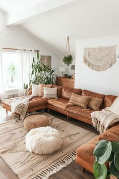 a living room filled with lots of furniture and pillows on top of a wooden floor