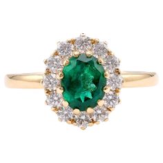 Brand: Trampet&Horn Center Stone: Emerald Cut: Oval Weight: Approximately 1.25 Carats Color: Green Accent Stone: 12 Diamonds Cut: Round Brilliant Weight: Approximately 0.58 Carats Color: F-G Clarity: VS Metal: 18K Yellow Gold Era: Vintage Inspired Circa: 2020s Hallmarks: 750 Purity Marks Size: 6.5 and can be resized Gram weight: 4.62 This exquisite ring from Trampet&Horn is a perfect blend of vintage inspiration and modern elegance. Crafted in luxurious 18K yellow gold, it features a stunning ov