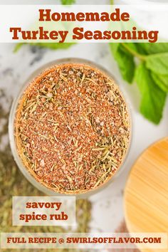 homemade turkey seasoning recipe in a glass bowl on a table with herbs and spices around it