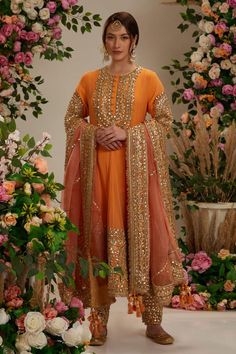 Peach orange georgette long anarkali with intricate gota work in floral pattern. Comes with matching salwar and pure organza dupatta.
Components: 3
Pattern: Embroidered
Type Of Work: Gota
Neckline: Round
Sleeve Type: Three Quarter
Fabric: Anarkali and Salwar: Georgette, Dupatta: Organza
Color: Peach,Orange
Other Details: 
Embellished show buttons
Kiran border dupatta
Model height: 5ft 7inches, wearing size S
Closure:
Kurta: Front hook and eye
Salwar: Drawstring tie-up
Occasion: Wedding,Puja - Az Peach Colour Combinations Indian Dress, Orange Anarkali Suits, Orange Suits Women Indian, Orange Punjabi Suit, Orange Indian Dress, Salwar Georgette, Gota Work Dress, Surface Development, Orange Anarkali