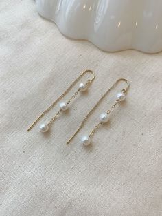 "These dainty Pearl threader earrings are classic and minimal. They look lovely paired with your special occasion outfits or a night out! The chain \"threads\" through the ear and stays in place!  Details: * Choose from 925 Sterling Silver or 14K Gold Filled * 5mm off round white Pearls * Approximately 2.25\" length * Made with all hypoallergenic materials 🤍 ✨ See all Pearl Jewelry here!: https://etsy.me/3zMbXyh WHAT TO KNOW ABOUT YOUR MAGBEE JEWELRY PURCHASE: 🤍 All MagBee pieces are safe for Dainty Chain Earrings, Elegant Simple Design Gold Earrings, Elegant Gold Earrings With Simple Design, Elegant Simple Gold Earrings, Dainty White Gold Linear Drop Earrings, Elegant Simple Drop Earrings, Minimalist 14k Gold Dangle Pearl Earrings, Elegant Drop Earrings With Simple Design, Dainty 14k Gold Filled Earrings For Formal Occasions