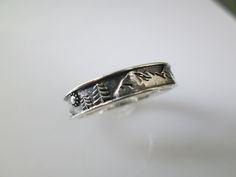 For all you Nature Lover's out there (me being one),this is a fabulous solid sterling silver Mountains and Trees ring with a little sun. It measures 5mm wide, and is crafted with an oxidized sterling back round and polished sterling mountains and trees on top of that. So it's quite a dynamic ring! Stamped 925. KEEP*IN*TOUCH FOLLOW and LIKE us on www.facebook.com/jkcorpjewelrycollection www.instagram@jkcorpjewelrycollection Thank you for visiting our shop! Moon Phase Ring, Mountains And Trees, Mountain Ring, Sun Ring, Silver Mountain, Mountain Jewelry, Back Round, Kids Rings, Nature Ring