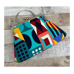 Gorgeous handmade geometric print clutch bag. The print is different on both sides. Use it as a clutch or attach the shoulder strap to wear over your shoulder or as a crossbody - Silver Chain strap (detachable) - Silver Metal Top handle ( not detachable) - Kiss lock clasp - H: 19cm x W: 28.5cm x D:4cm approximately - Metal clasp: H: 6.5cm x W: 20cm - Top handle: H:8.5cm Due to different monitor settings, colours may differ slightly from those pictured More colours and designs available here: https://www.etsy.com/uk/listing/1577141850/ https://www.etsy.com/uk/listing/1537782617/ https://www.etsy.com/uk/listing/1580955173/ Women 70s, Boho Handbag, Boho Handbags, Colorful Handbags, Handbag Vintage, Vintage Handbag, Printed Clutch, Handbag For Women, Vintage Handbags