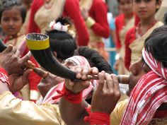 some people are dressed in red and white with an elephant's tusk on their head