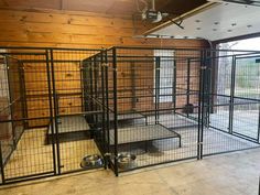 several cages are set up in the middle of a room