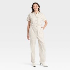 Elevate your wardrobe with this Boilersuit from Universal Thread™. Made from recycled cotton with added spandex, this boilersuit features relaxed-fit legs and an ankle length. The boilersuit comes in a short-sleeve design with a collared neckline and boasts multiple pockets for practicality. The elastic waistband and front buttons add extra flair for an on-trend look. Universal Thread™: Found exclusively at Target. Cream Jumpsuit, Cargo Jumpsuit, Boiler Suit, Women Maxi, Fabric Collars, Hem Style, Universal Thread, Sleeve Designs, Recycled Cotton