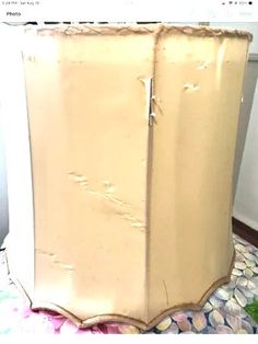 an old white cabinet with peeling paint on the top and bottom, sitting on a rug