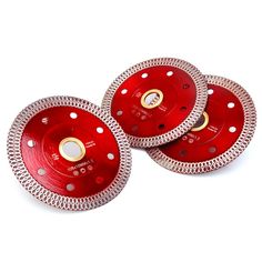 three red diamond grinding discs on white background