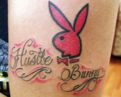 a woman's leg with a bunny rabbit tattoo on it and the words hustle, bunnies written in cursive writing