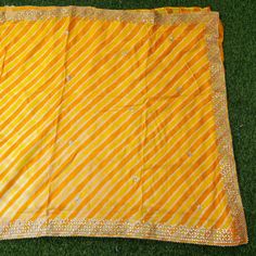 Fabric - Pure Tussar Silk Tussar silk is an exquisite thread obtained from a wide-winged moth that is slightly yellowish-brown in color. Tussar is mainly valued for its texture, charm, and natural gold color, which is unusually rich and deep. It is the primary kind of silk, which has a lustrous, bright, soft hand feel and has the highest wear resistance in the natural fabric. Craftsmanship- Gotta Patti Color - Yellow Leheriya Blouse - Plain with border Note- There may be slight color variations Yellow Silk Sharara With Dupatta, Yellow Silk Sharara For Navratri, Yellow Saree With Gota Work For Navratri, Ceremonial Silk Traditional Wear With Gota Work, Yellow Chanderi Traditional Wear With Dori Work, Yellow Saree With Gota Work And Traditional Drape, Yellow Saree With Gota Work, Yellow Silk Sharara With Zari Work, Semi-stitched Yellow Saree With Gota Work