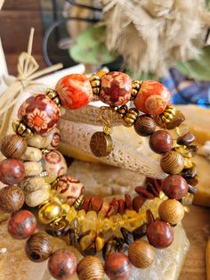 Boho/Hippie Style Bracelet. Made with Gold Memory Wire, Multi Colored Glass Beads ,Natural Colored Beads, Citrine Chip Beads, Gold Antiqued Spacer Beads, Red Jasper Chip Beads, Multi Colored Orange/Jasper Beads with Flower Design, Tiger Eye Chip Beads, Golden Tree Charm on one end Boho Beads, Boho Style Bracelets, Boho Hippie Style, Golden Tree, Jewelry Lookbook, Chip Beads, Jasper Beads, Memory Wire, Handmade Boho