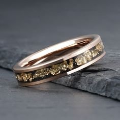 two wedding bands with gold leaves on them