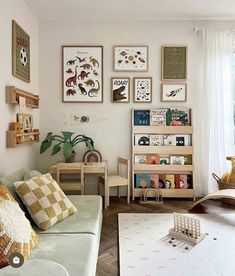 a living room filled with furniture and pictures on the wall