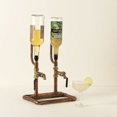 two wine glasses sitting next to each other on top of a wooden stand near a martini glass