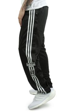 ADIDAS Black sport pants for men. Originally created for warming up on the pitch, the adidas adibreak pants have become a symbol of freedom of expression. Unbutton them at the ankles, up to the knees, or keep all the buttons closed, you decide how to wear them. The model wears a size L and is 187cm tall. Medium temperature washing and ironing is recommended. Autumn winter season. ATHLETES WORE THEM FIRST. NOW IT'S YOUR TURN. ORIGINALLY MADE FOR WARMING UP ON THE PITCH, THE ADIDAS ADIBREAK TRACK Adidas Track Pants Outfit Men, Adidas Pants Outfit Men, Adidas Track Pants Outfit, Adibreak Track Pants, Adidas Pants Outfit, Adidas Adibreak, Adidas Outfit Men, Adidas Trousers, Track Pants Outfit