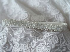 Introducing our Bespoke and Elegant Wedding Garter Adjourned with Small White Beads.    This bead adjourned garter is all about comfort and style. Crafted from stretchy elastic, it's designed to fit you perfectly, ensuring you're at ease as you dance the night away.  Crafted with love and attention to detail, this garter is more than an accessory - it's a cherished keepsake that captures the essence of your special day.  Why Choose Our Pearl Wedding Garter:  🌸 Uniquely Bespoke: Exclusive design you won't find anywhere else. Your garter will be as special as your love story.  🌸 Perfect Bridal Gift: Searching for the ideal bridal gift? Look no further. Our beaded garter is a heartfelt gift that will be treasured for years to come.  🎁 Each garter comes beautifully wrapped in a gift box.  M Fitted Bridal Accessories With Pearl Embroidery For Wedding, Beaded Pearl Bridal Accessories For Wedding, Fitted Beaded Bridal Belt For Wedding, Silver Beaded Bridal Accessories For Wedding, Adjustable Beaded Bridal Accessories For Wedding, Adjustable Pearl Bridal Accessories For Wedding, Adjustable Embellished Bridal Belt For Wedding, Beaded Bridal Accessories For Wedding, Beaded White Bridal Belt For Party