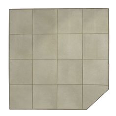 a white tiled wall with square tiles on the top and bottom half, in an angled position