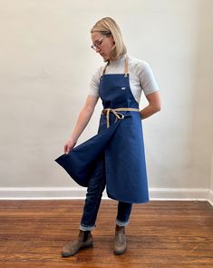 a woman in an apron is holding something