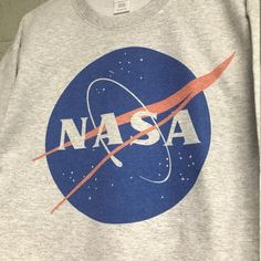 Nasa Meatball logo Heather ash gray Sweatshirt Gray Cotton Sweatshirt With Logo Print, Gray Cotton Sweatshirt With Graphic Print, Athletic Heather Cotton Sweatshirt With Graphic Print, Cotton Athletic Heather Sweatshirt With Graphic Print, Graphic Print Cotton Sweatshirt In Athletic Heather, Gray Cotton Pre-shrunk Sweatshirt, Heather Grey Cotton Sweatshirt With Logo Print, Gray Relaxed Fit Sweatshirt With Screen Print, Space Day