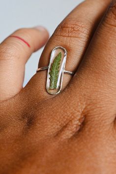 ✿description >m a d e to o r d e r < - .925 sterling silver ring - non-toxic+uv-resistant, BPA free resin. Safe for everyday wear - due to natural limitations, the ferns may vary from the ferns in the photo. this ring takes two weeks to create & ship. If you need expedited shipping please contact me before purchasing Mini Here: https://www.etsy.com/listing/983844411/silver-mini-fern-ring?ref=shop_home_active_3 More Rings Here: https://www.etsy.com/shop/mentalgardens/?section_id=2709362 Nature-inspired Pressed Flower Ring Jewelry, Nature-inspired Rings With Natural Inclusions For Promise, Nature-inspired Silver Rings With Natural Inclusions, Nature-inspired Promise Rings With Natural Inclusions, Nature-inspired Ring With Natural Inclusions, Fern Ring, Dried Fern, Fairytale Ring, Garden Ring