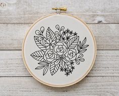 an embroidery hoop with a flower design on it