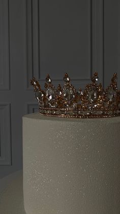 a white cake with a gold crown on top