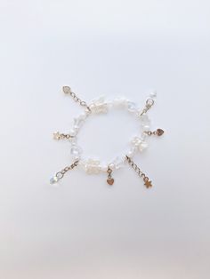 ・❥・White Themed Bracelet, adorned with dangling silver toned and teardrop charms.        ・❥・Opaque and acrylic hearts, star, butterfly and pearl beads make up the bracelet.  ・❥・Bracelet length is about 7.5 inches.  ・❥・Can be adjusted, just make sure to contact me!  ・❥・Perfect as a gift or for any occasion! Dainty White Bracelets With Charms, White Charm Bracelet With Star Charm As Gift, White Dangle Charm Bracelet, White Dangle Jewelry With Butterfly Charm, Dainty White Charm Bracelet With Pearl, White Metal Jewelry With Butterfly Charm, White Metal Dangle Charm Bracelet, White Dainty Metal Charm Bracelet, Dainty White Metal Charm Bracelet