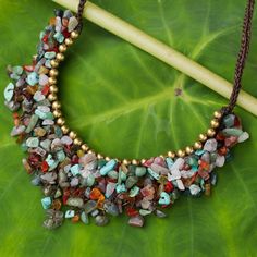 Be the life of the party with this stylish beaded necklace from Tiraphan Hasub in Thailand. The dramatic cord necklace features myriad colorful gemstone chips knotted together including dyed calcite carnelian aventurine rose quartz and enhanced jasper. The gems are topped with shiny brass beads for contrast. The necklace fastens with a toggle crafted of assorted gemstone nuggets. Gemstone Chips Jewelry, Gemstone Chip Necklace, Homemade Necklaces, Beaded Necklace Diy, Jewel Necklace, Handmade Jewelry Necklace, Handmade Beaded Necklaces, Humidor, Beaded Anklets