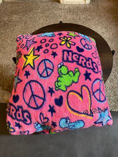 a pink pillow with peace and teddy bears on it