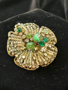 Meticulously Beaded Brooch with various shades of green rhinestones, some with clear swirls. Set on heavy filigree base. Signed Originals by Robert. Rare. Elegant Green Rhinestone Brooches, Green Brooch For Party, Ornate Green Jewelry For Evening, Vintage Green Rhinestone Brooches, Green Vintage Rhinestone Brooches, Antique Green Brooch For Evening, Vintage Green Rhinestone Brooch, Vintage Green Brooch For Evening, Handmade Green Brooch For Formal Occasions