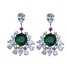 Emerald and Diamond earrings showcase a beautiful dark green stone surrounded by sparkling CZ diamonds. With their modern yet classic design, these statement hangings are both cute and elegant, making them a perfect wedding or anniversary gift. Ideal for adding a touch of sophistication to any special occasion. *𝐏𝐑𝐎𝐃𝐔𝐂𝐓 𝐃𝐄𝐓𝐀𝐈𝐋* * 𝐌𝐚𝐭𝐞𝐫𝐢𝐚𝐥: Brass * 𝐏𝐥𝐚𝐭𝐢𝐧𝐠: White Rhodium Plated * 𝐒𝐭𝐨𝐧𝐞: AAA-quality CZ diamond, Emerald. *𝐃𝐈𝐌𝐄𝐍𝐒𝐈𝐎𝐍𝐒* * 𝐖𝐞𝐢𝐠𝐡𝐭: 1.50 g Formal Green Diamond Cluster Earrings, Elegant Green Diamond Cluster Earrings, Green Diamond Chandelier Drop Earrings, Green Diamond Earrings For Formal Occasions, Green Drop Diamond Earrings For Wedding, Green Diamond Drop Earrings For Bridal, Green Diamond Drop Bridal Earrings, Green Diamond Bridal Earrings For Formal Occasions, Formal Green Diamond Bridal Earrings