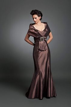 Exude a classy appeal and be ready to fascinate everyone in this picture-perfect gown by Daymor 1033. The long formal gown has a stunning wide V neckline camisole top, covered by a narrow off-shoulder faux-wrap jacket, accented by an oversized square buckled waistband wrapping the empire waistline. The look finishes with a stunning floor-rushing mermaid skirt that is fitted through the hips and flares at the hem. This Daymor Couture is perfect for formal gathering or wedding, especially fitting Daymor Couture, Gown With Jacket, Gowns Couture, Off Shoulder Evening Dress, Long Formal Gowns, Off Shoulder Gown, Trumpet Gown, Mob Dresses, Couture Dress