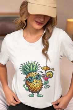 Get into the summer spirit with this vibrant unisex t-shirt featuring a cool pineapple wearing sunglasses and holding a tropical cocktail. Perfect for beach days, vacations, luau parties, or as a fun gift for fruit lovers. Made with soft, lightweight fabric, this tee offers a comfortable fit for any occasion. Whether you're relaxing by the pool or hitting the beach, this shirt is your go-to for showcasing your tropical vibes in style. We utilize the authentic Bella Canvas 3001 brand, renowned for its UNISEX design, making it one of the most sought-after shirts in the market. Prior to placing an order, kindly refer to our size chart. It can be located in both the listing's images and description. This cozy T-shirt serves as an ideal present, suitable for occasions such as birthdays, Christm Tropical Print T-shirt For Vacation, Funny Sublimation Print Tops For Summer, White Tropical Print T-shirt For Summer, Funny Short Sleeve Summer Tops, Funny Short Sleeve Tops For Summer, Fun Graphic Print Hawaiian Shirt For Vacation, Funny Crew Neck T-shirt For Summer, Fun Hawaiian Shirt For Summer Vacation, Fun Summer Hawaiian Shirt For Vacation