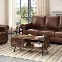 a living room with two couches and a coffee table in front of a window