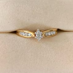 a gold ring with white diamonds on it