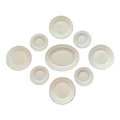 six white paper plates on a white background