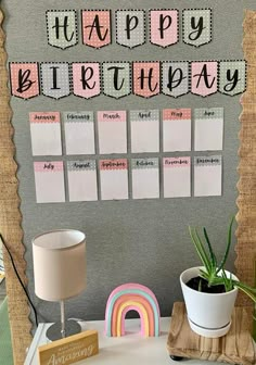 a desk with a potted plant and a sign that says happy birthday