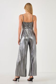 This Metallic Cowl Neck Cami Jumpsuit will be sure to keep you looking fashionable. This chic piece is designed with an all over metallic jersey fabric that contains a cowl neck cami bodice and an elastic band at the back for added comfort. It also features a center back zipper closure for easy on and off. This beautiful, one-of-a-kind jumpsuit is a must-have piece that is sure to elevate your wardrobe! Cowl neck cami bodice All over metallic jersey Elastic band at back bodice Center back zipper Fitted Spaghetti Strap Jumpsuits And Rompers For Party, Metallic Fitted Jumpsuits And Rompers For Party Season, Sleek Summer Party Jumpsuits And Rompers, Glamorous Fitted Jumpsuits And Rompers With Shimmer, Glamorous Fitted Shimmer Jumpsuits And Rompers, Shimmer Jumpsuits And Rompers For Party Season, Metallic Stretch Jumpsuits And Rompers For Party, Metallic Sleeveless Jumpsuit For Night Out, Metallic Sleeveless Jumpsuits And Rompers For Party