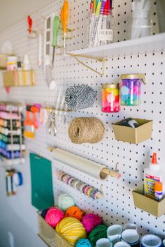 there are many craft supplies hanging on the wall