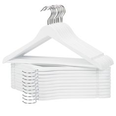 a stack of white clothes hangers on a white background with clippings attached to them