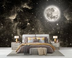 a bed sitting under a large moon in the middle of a night filled with stars