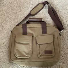 Never Used-Perfect Condition! Bella Rosa Bag - Messenger Bag, Laptop Bag, Briefcase, Whatever You Need It To Be! Exterior Is Olive Green/Light Brown Canvas With Brown Nylon Straps And Brown Leather Accents. Two Exterior Pockets And Removable Shoulder Strap. Interior Is Black Nylon With Four Compartments. 12” X 11” X 3”. Khaki Tote Bag For On-the-go, Canvas Laptop Shoulder Bag For On-the-go, Khaki Double Handle Bag For On-the-go, Khaki School Tote Satchel, Khaki Large Capacity Satchel For Everyday Use, Khaki Canvas Travel Bag For Everyday Use, Everyday Use Khaki Canvas Travel Bag, Khaki Canvas School Bag With Removable Pouch, Functional Khaki Bags For Daily Use