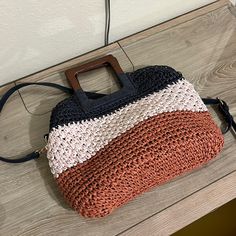 Cute Sasha And Sofi Straw Bag A Nice Crme Color, Navy And A Burnt Orangey Color Wooden Handles, Adjustable And Removable Strap Never Used Does Have Some Minor Flaws Such As Handles And Bit Of The Straw Great For Summer! Casual Crochet Beach Bag With Detachable Handle, Casual Beach Crochet Bag With Detachable Handle, Chic Crochet Bag With Detachable Strap For Vacation, Chic Crossbody Beach Satchel, Trendy Crossbody Hobo Bag For Beach, Chic Beach Crossbody Satchel, Trendy Square Satchel For Beach, Chic Rectangular Beach Bag For Day Out, Trendy Crochet Vacation Bag With Detachable Handle