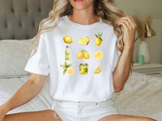 Introducing our zesty Comfort Color t-shirt featuring a refreshing lemon design. Made for those who crave a burst of brightness in their wardrobe, this tee combines comfort and style effortlessly. Crafted with the softest fabric and boasting a relaxed fit, it's perfect for adding a splash of citrus charm to your everyday look. Whether you're lounging at home or out and about, this lemon t-shirt is sure to add a sunny touch to any ensemble. Embrace the zest for life and elevate your wardrobe today! Each shirt is carefully printed with high-quality, eco-friendly inks, ensuring vivid colors that remain vibrant wash after wash. Whether you're exploring the farmer's market, enjoying a leisurely stroll, or simply lounging at home, this tee adds a touch of nature-inspired flair to any outfit. 🍋 White T-shirt With Lemon Print For Summer, Casual Lemon Tops For Summer, Short Sleeve Lemon Print Graphic Tee, White Crew Neck T-shirt With Lemon Print, Summer Lemon Print Graphic Tee, White Lemon Print T-shirt For Summer, Summer Short Sleeve T-shirt With Lemon Print, Short Sleeve Lemon Print T-shirt For Summer, White Short Sleeve T-shirt With Lemon Print