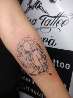 a woman's arm with a tattoo on it