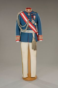 a toy soldier is dressed in blue and white with a red stripe on his uniform